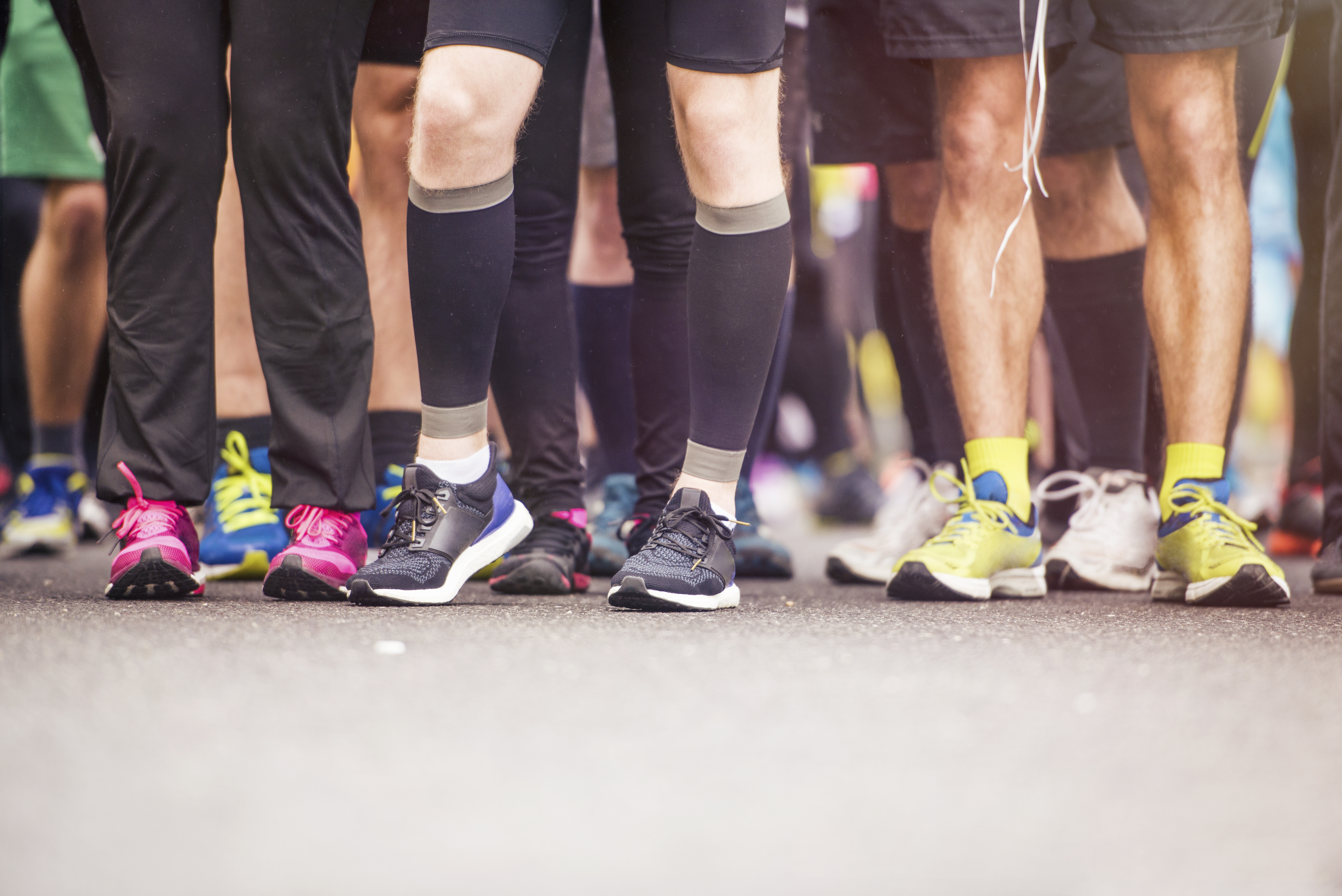 Detail of the legs of runners at the start of a marathon race